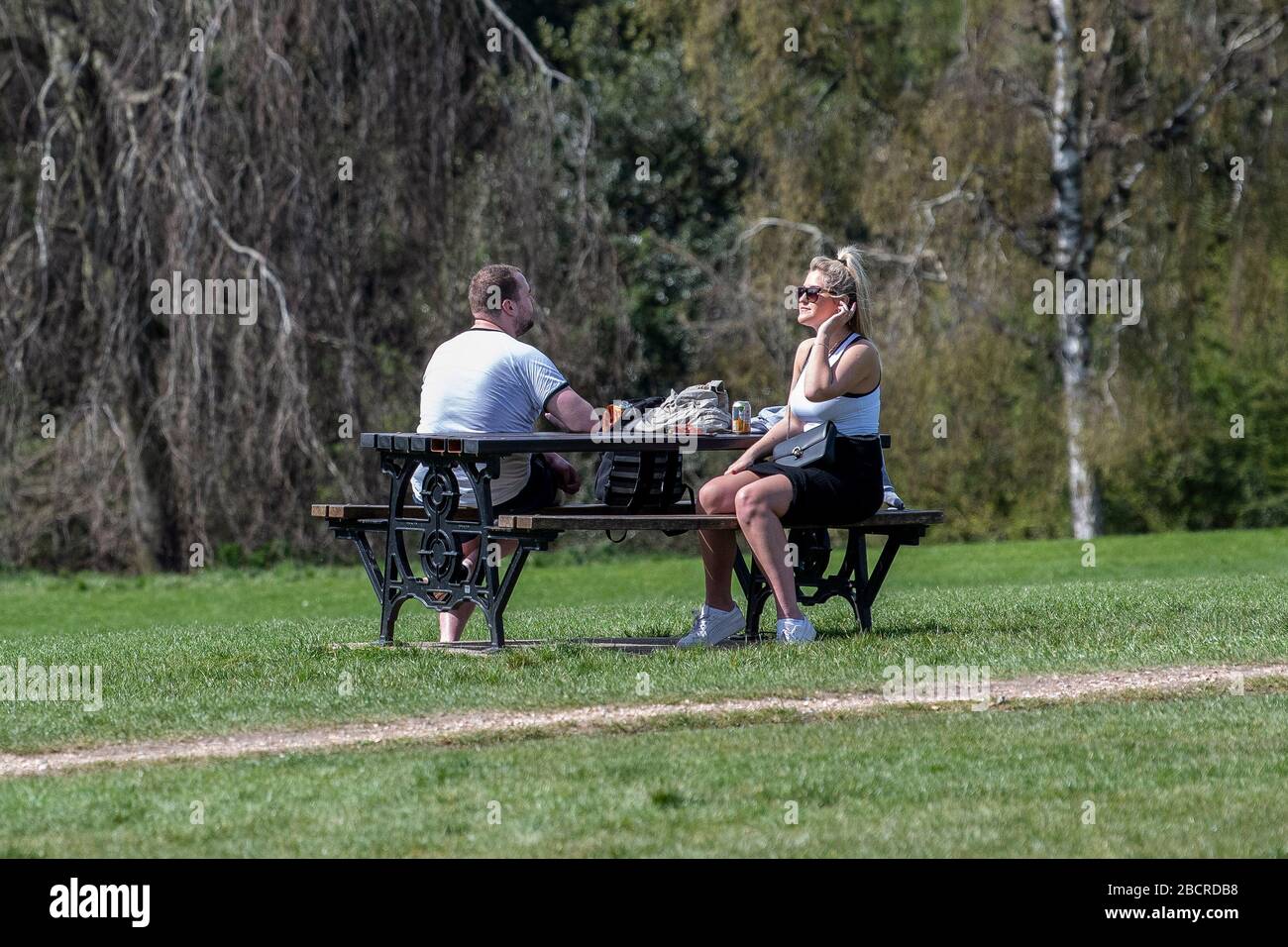 05.04.20. Coronavirus Pandemic, Bath.  A couple enjoy a picnic in the sunshine in Royal Victoria Park in Bath, Somerset, as the UK government restrict Stock Photo