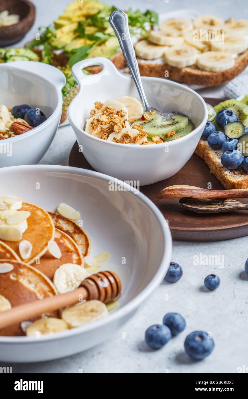 Healthy varied vegetarian breakfast table. Oatmeal with fruits, chia ...