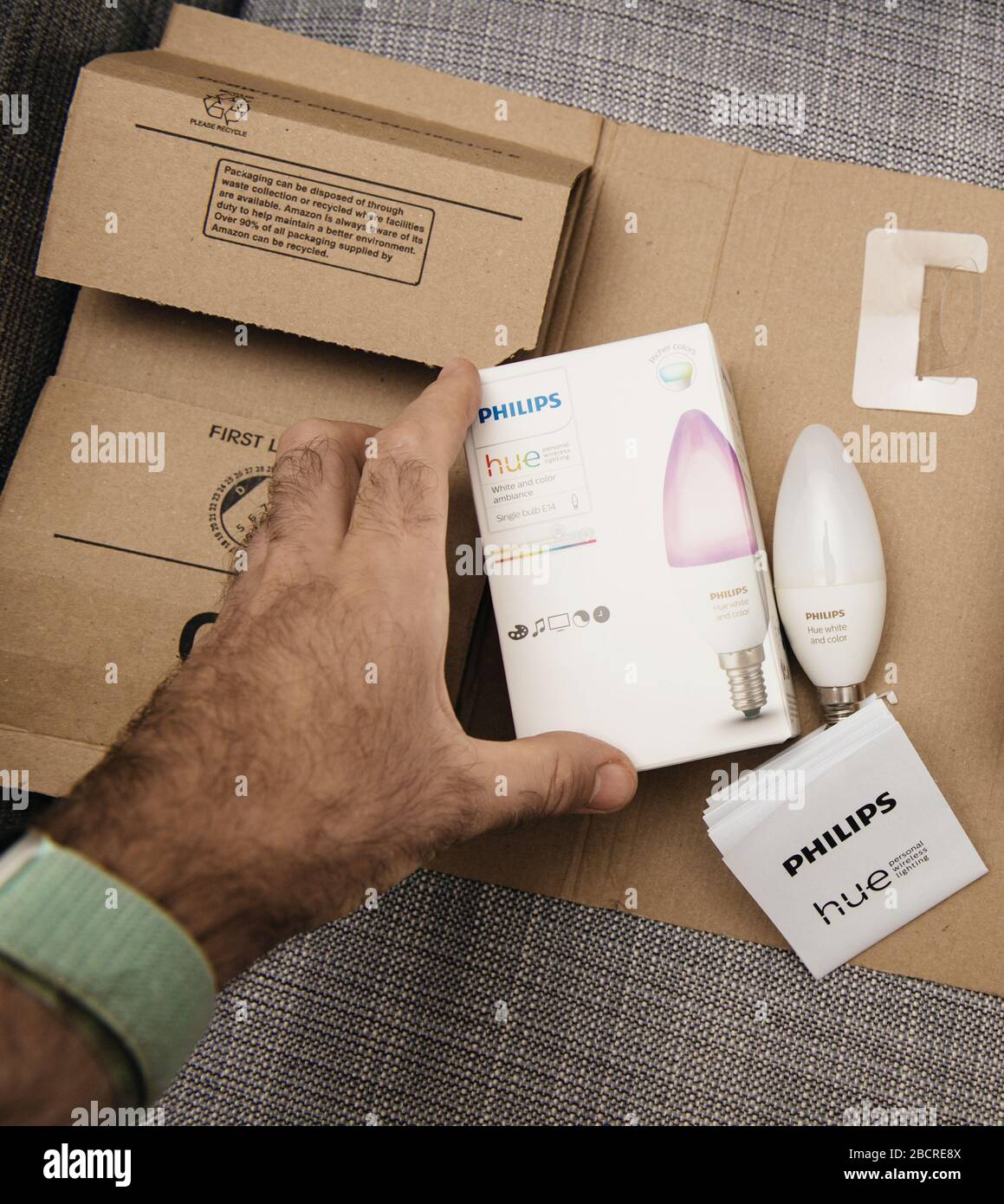 Paris, France - Aug 7, 2019: View from above of male hand unboxing parcel  from Amazon Prime with two new internet connected Philips Hue E14 color and white  ambiance bulb Stock Photo - Alamy