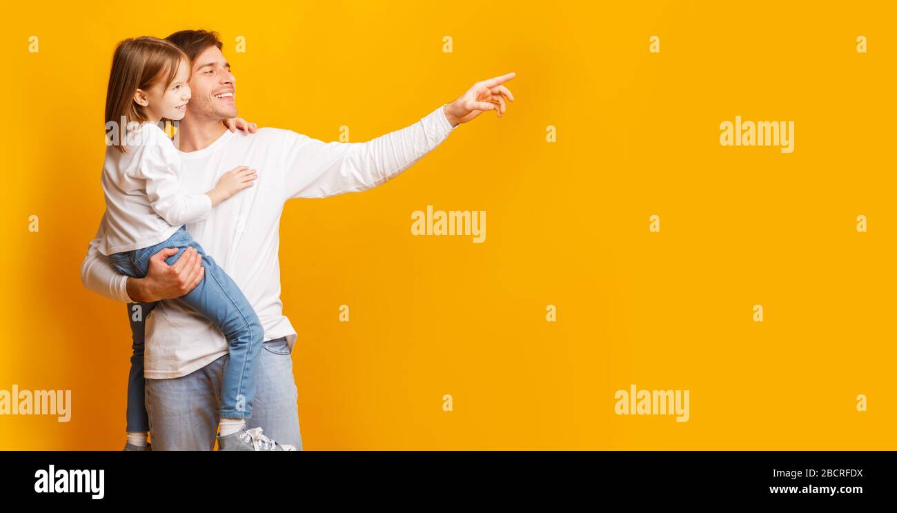 Excited young father pointing at copy space Stock Photo