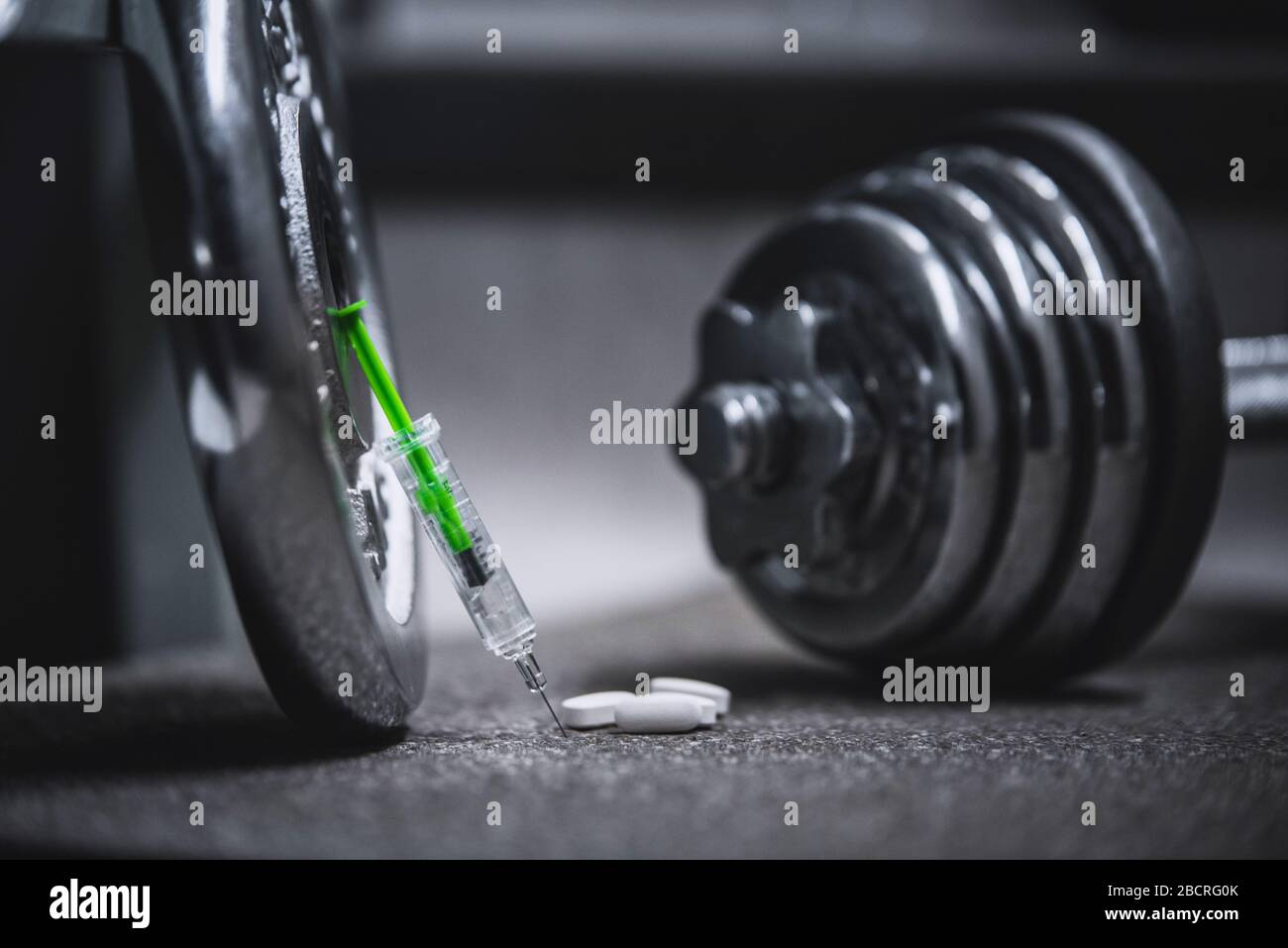 Syringe and stethoscope on a metal surface Stock Photo