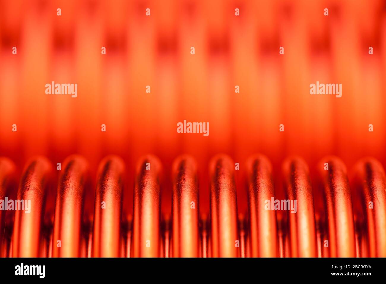 Detail of a hot heat exchanger or recuperator in orange red - selective focus Stock Photo