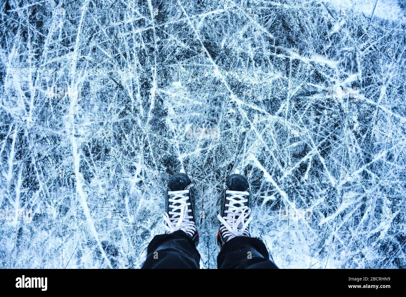 hockey background with skates on natural ice and space for your montage