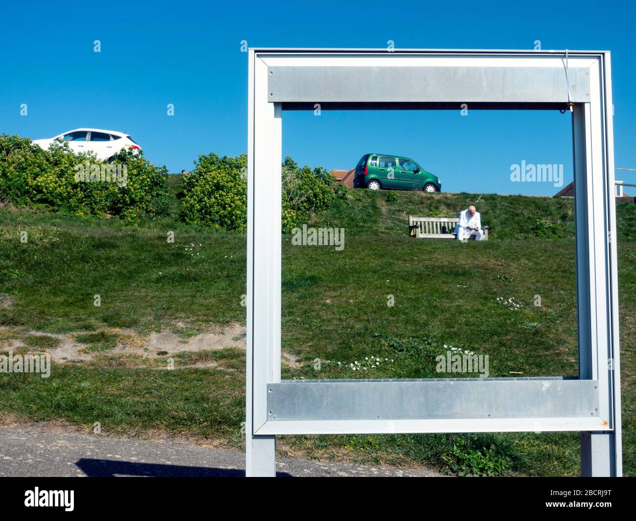 Man in a white suit sitting alone on a park bench Stock Photo - Alamy