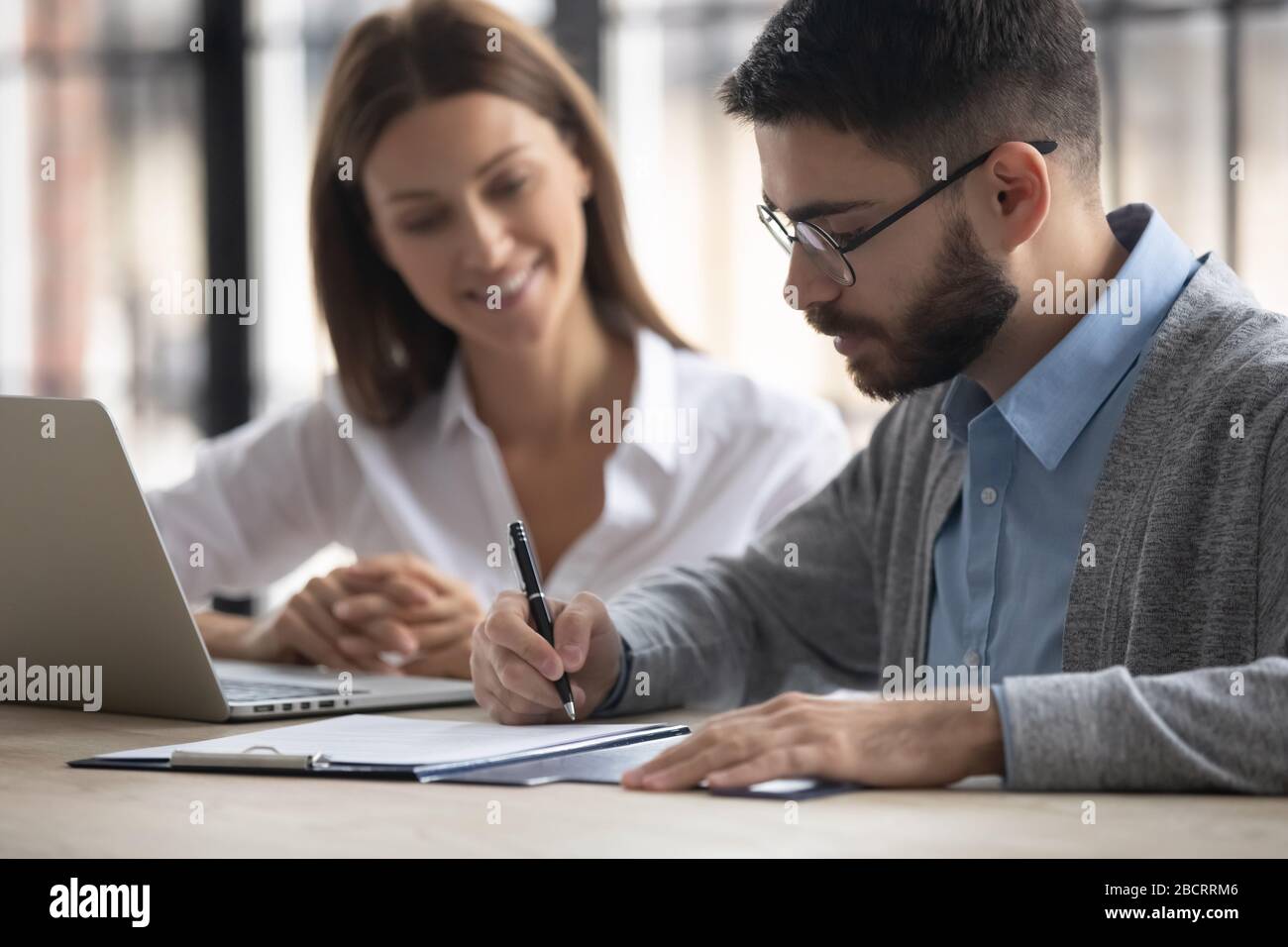 Close up handsome businessman signing partnership agreement concept. Stock Photo
