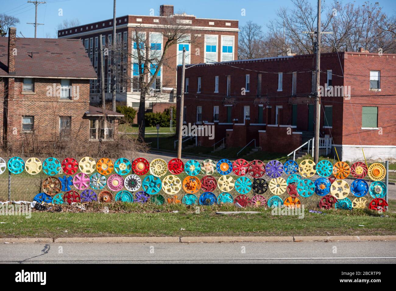 Pontiac, Michigan - Painted hubcabs decorate a fence. Stock Photo
