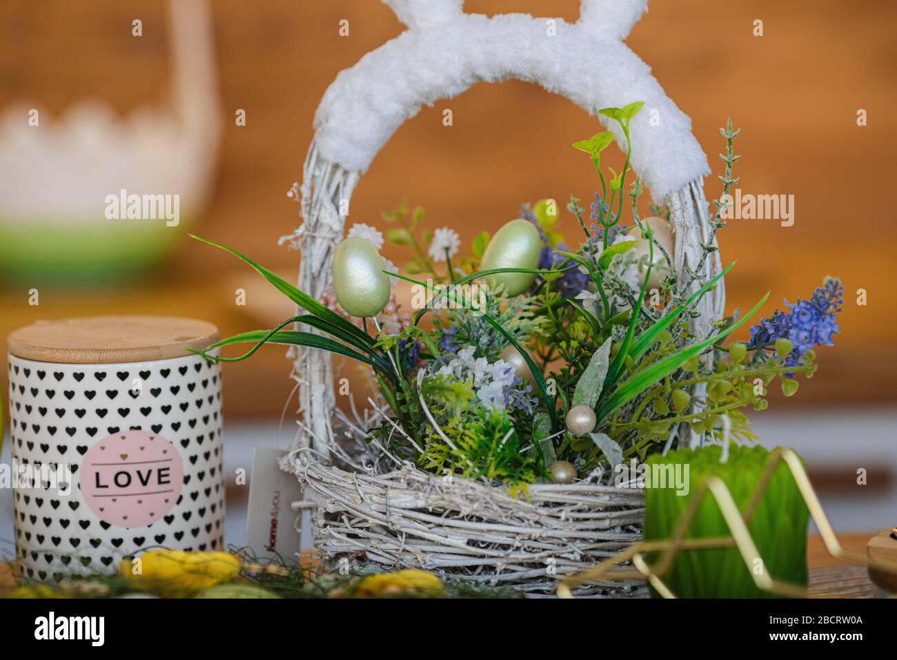 Festive Easter basket with flowers on the table Stock Photo