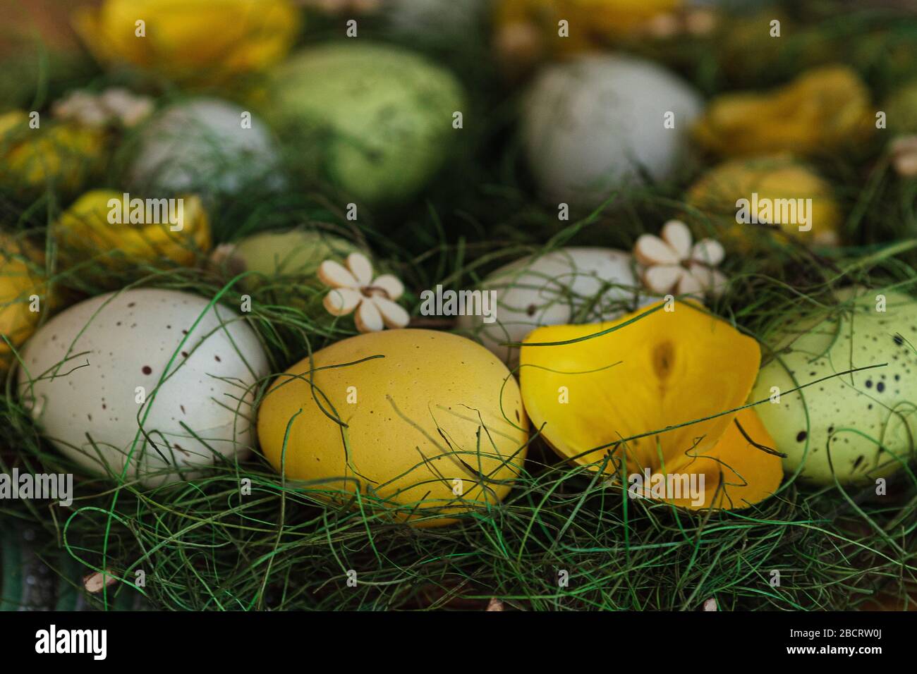 Festive Easter basket with multicoloured eggs on the table Stock Photo
