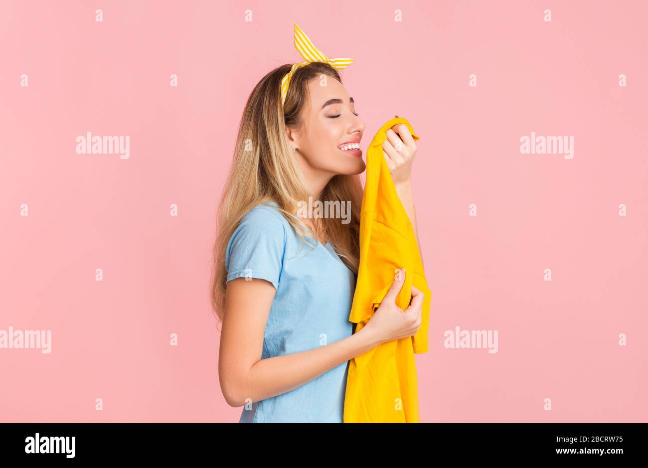Funny housewife smelling clean tshirt, free space Stock Photo