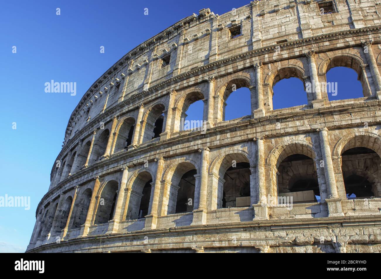 Colosseum at blue sky in Rome, Italy, Europe. Rome ancient arena for gladiator fights. Stock Photo