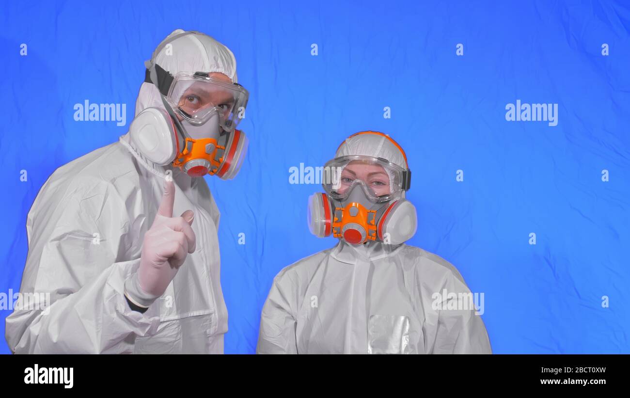 Doctor health worker in respirator. Slow motion. People portrait, wearing protect medical antibacterial antiviral aerosol spray paint mask. Stock Photo