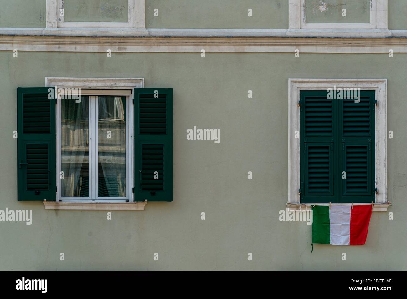 italian flag on window during coronavirus quarentine in genoa Italy Stock Photo
