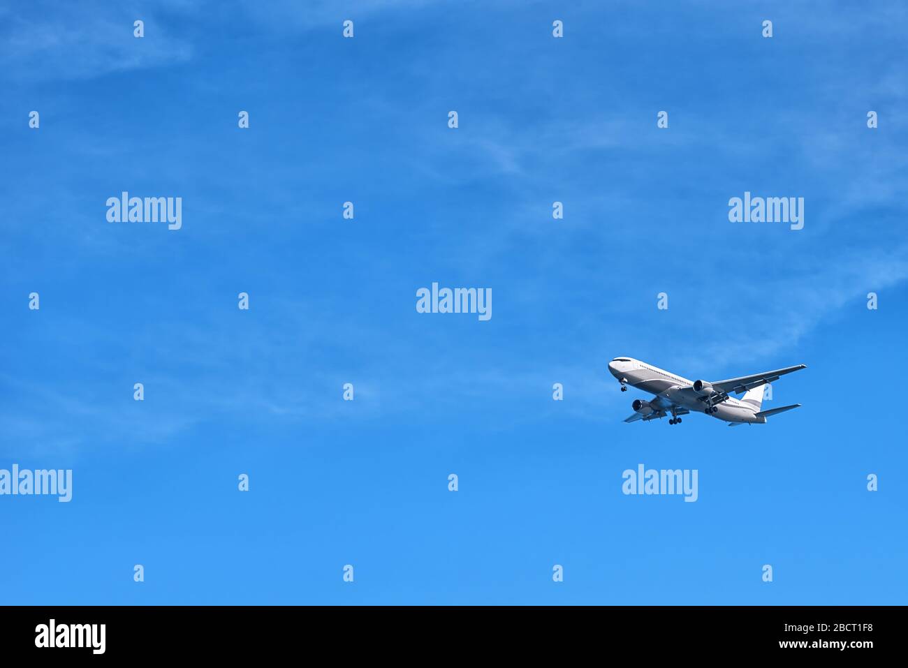 The airplane flying in the sky a close up the bottom view Stock Photo