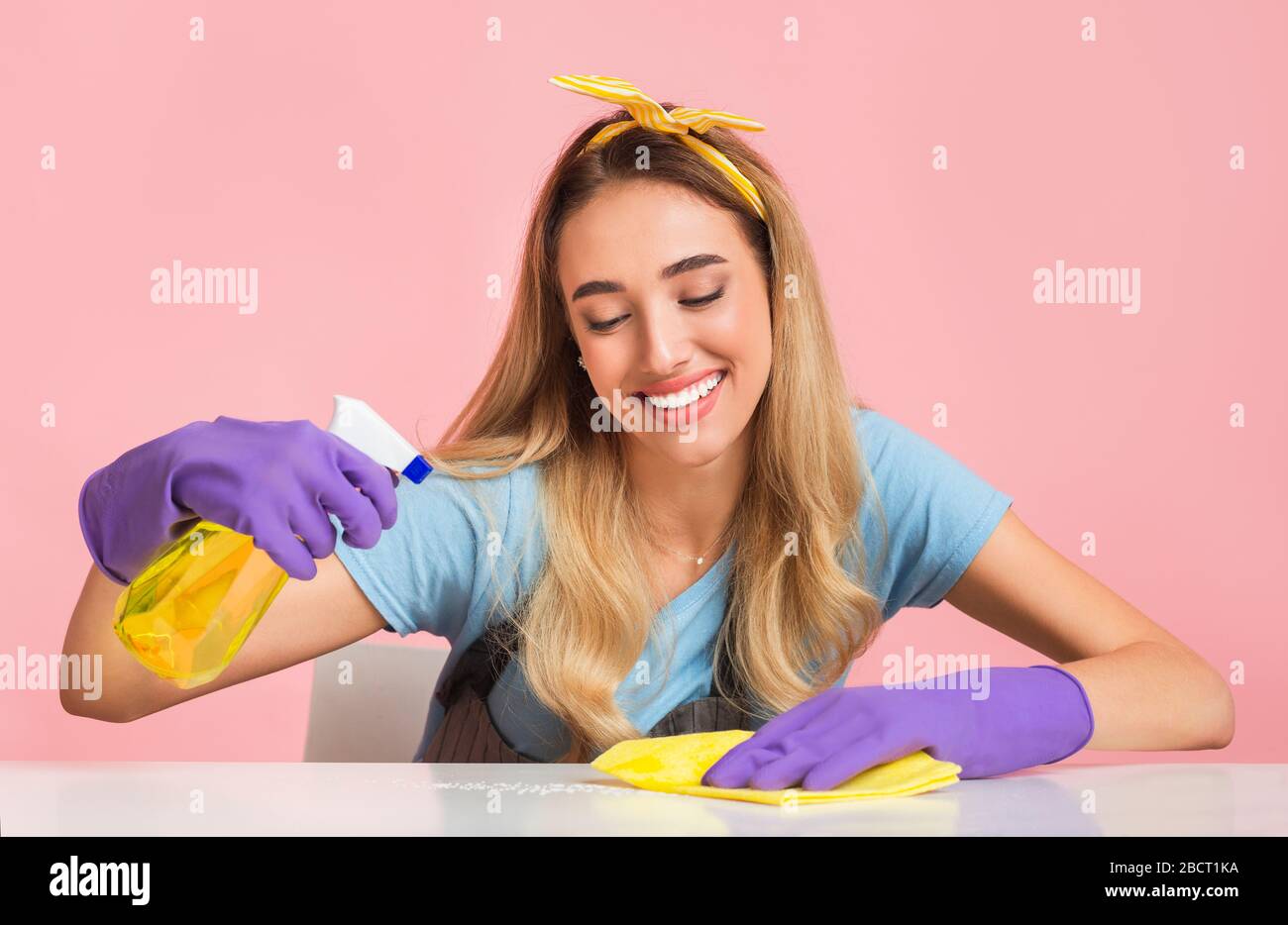 House cleaning with smile. Housewife wipes dust Stock Photo