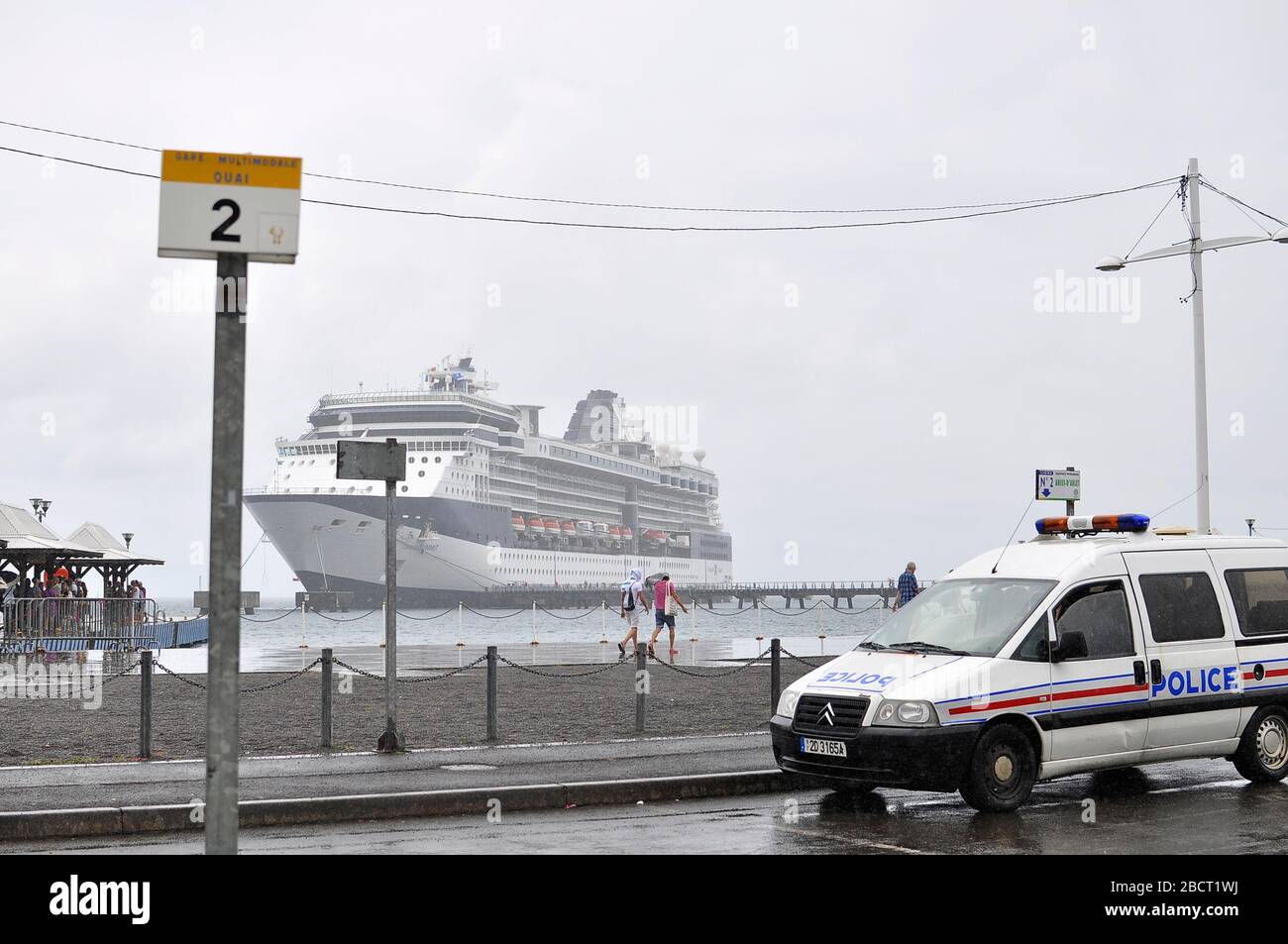 View of the cruise ship Celebrity Summit from the dock od Fort de France  and a police car parked as it rains.Weather conditions in the Caribbean. Stock Photo