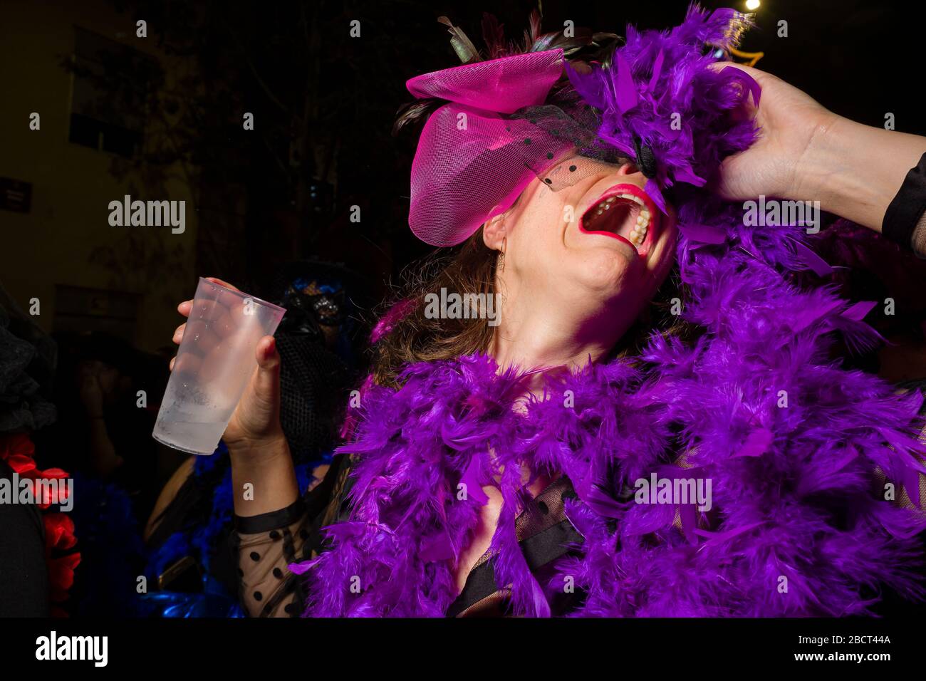 A woman, dressed up in mourning clothes and crying, partying in the streets during the funeral procession Burial of the Sardine Stock Photo