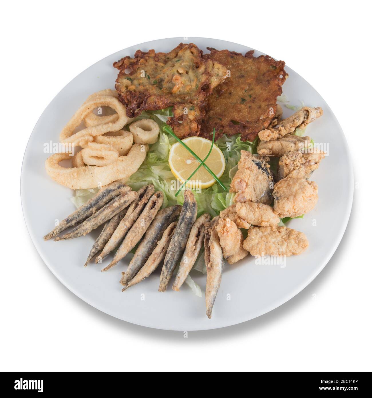 Fried fish dish with anchovies, squid, marinade and shrimp fritters. Stock Photo