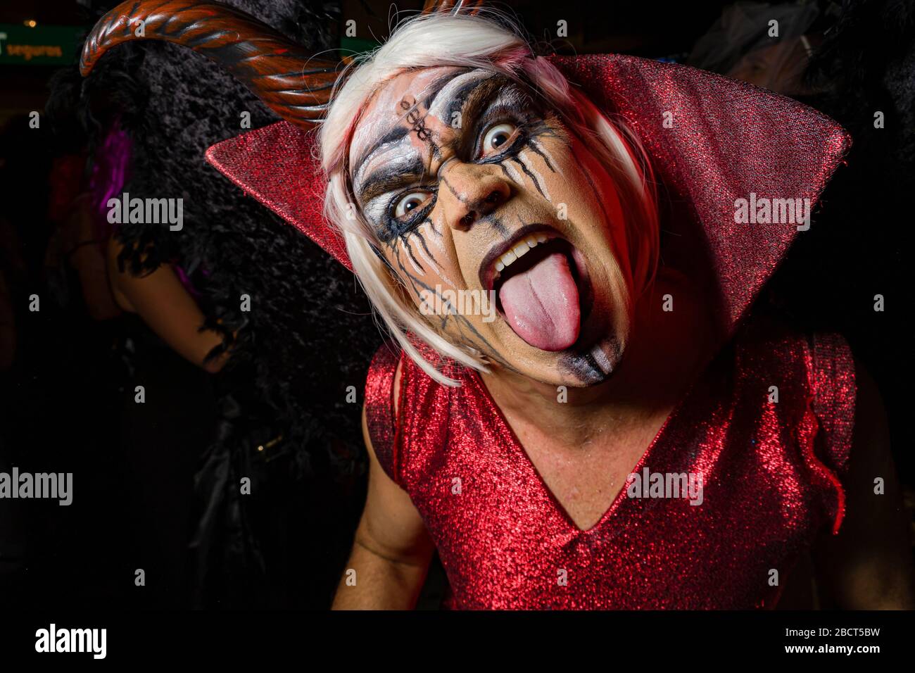 A man, dressed up as a wild animal, partying in the streets during the funeral procession Burial of the Sardine Stock Photo