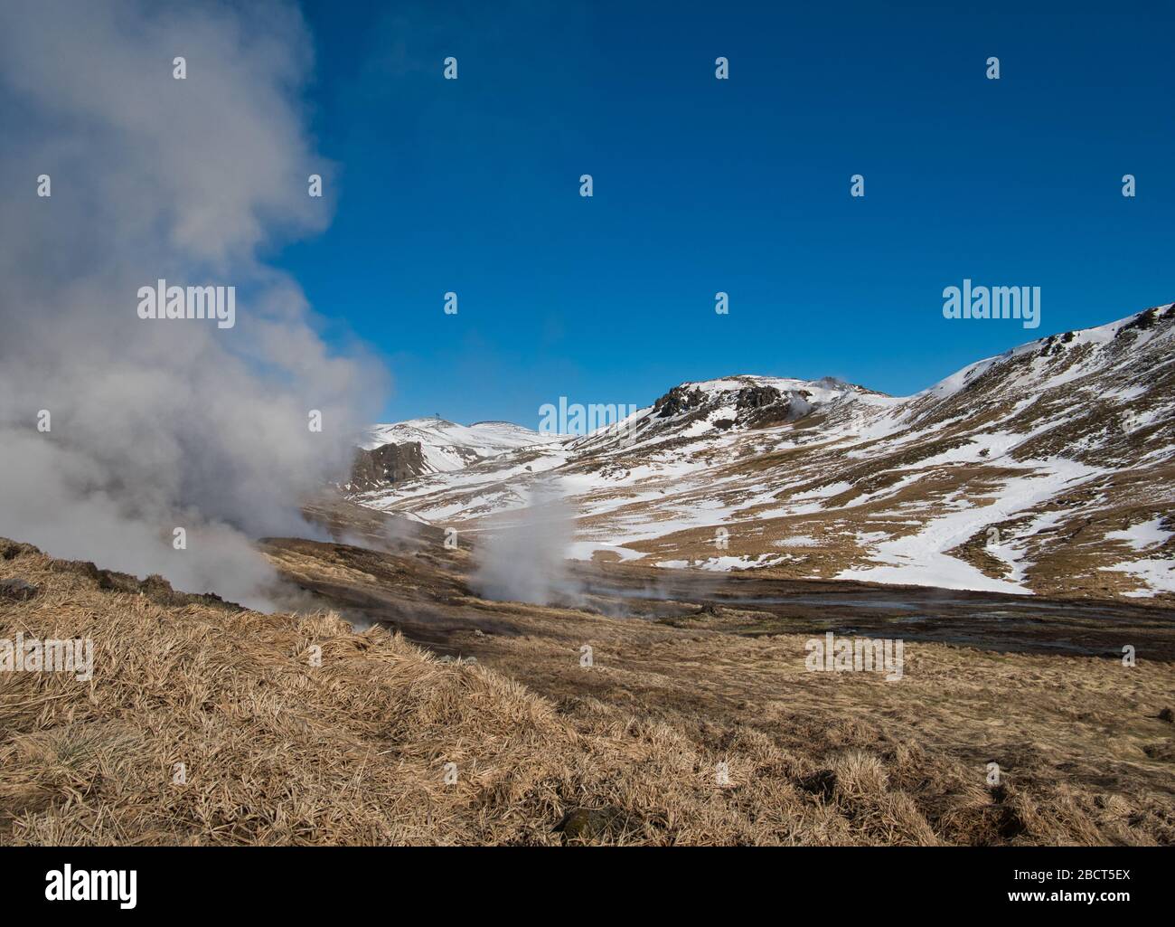 The rising steam from geothermal sources in Iceland near Reykjadalur Stock Photo