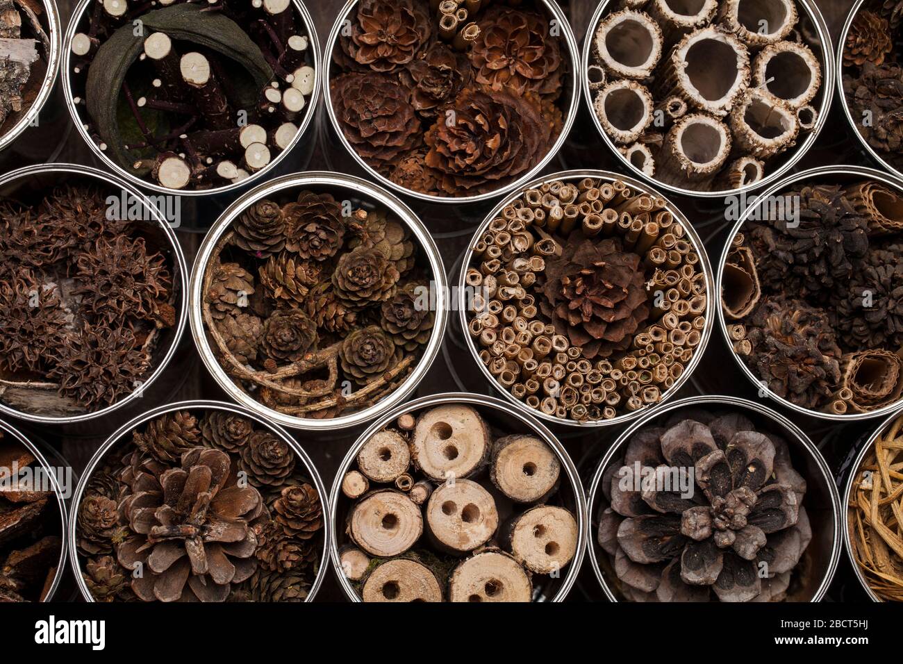 Insect house hotel, made of used coffee cans and various wooden and