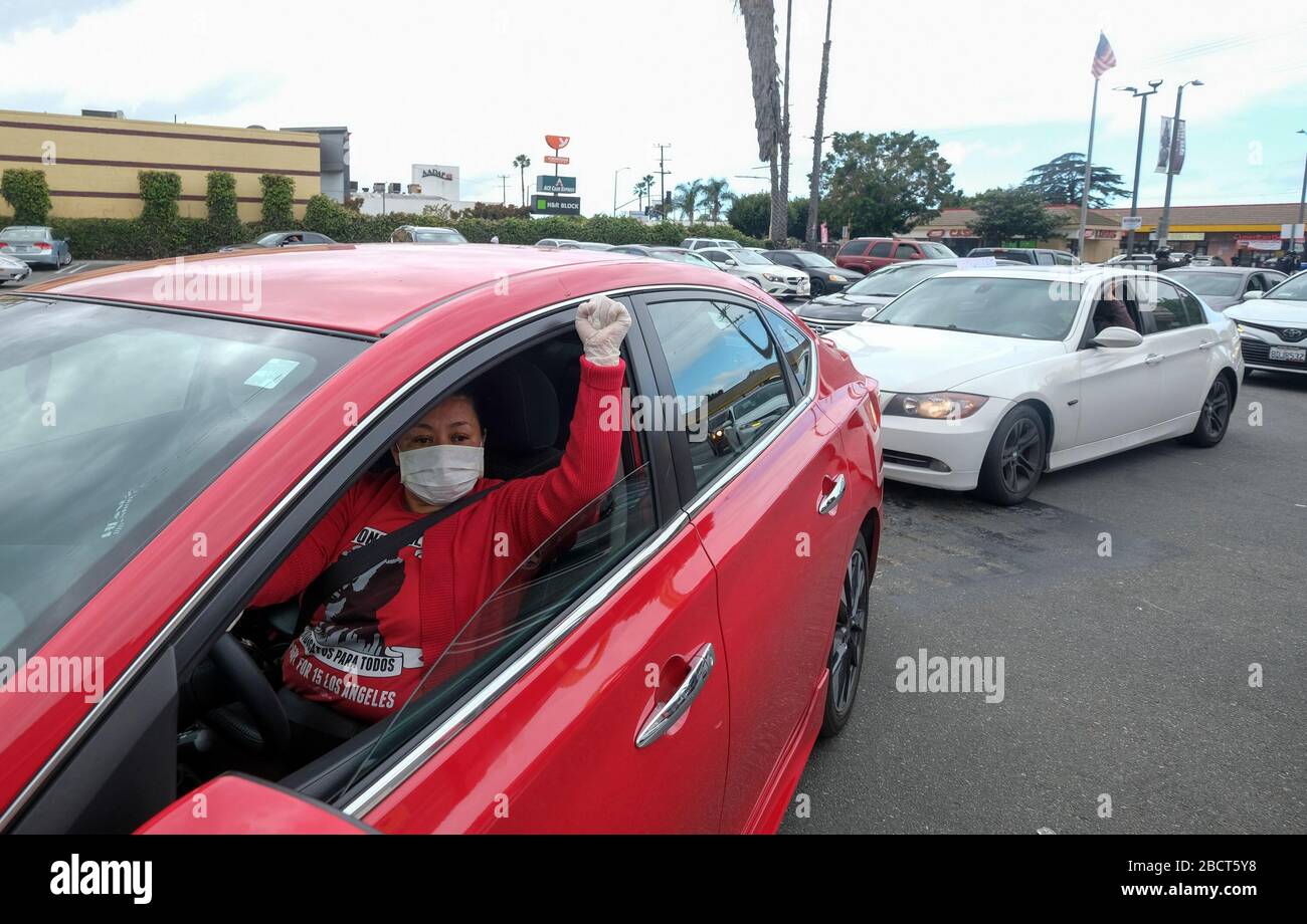 Los Angeles, California, USA. 5th Apr, 2020. A worker wearing a face mask and gloves takes part in a drive-thru ''strike'' at a McDonald's restaurant on Sunday, April 5, 2020 in Los Angeles. The workers are demanding a two-week quarantine period, with full pay for a co-worker who tested positive for COVID-19. Credit: Ringo Chiu/ZUMA Wire/Alamy Live News Stock Photo