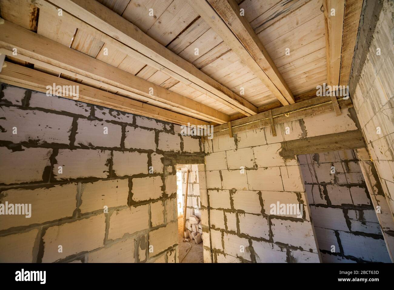 House room interior under construction and renovation. Energy saving walls  of hollow foam insulation blocks, wooden ceiling beams and roof frame Stock  Photo - Alamy