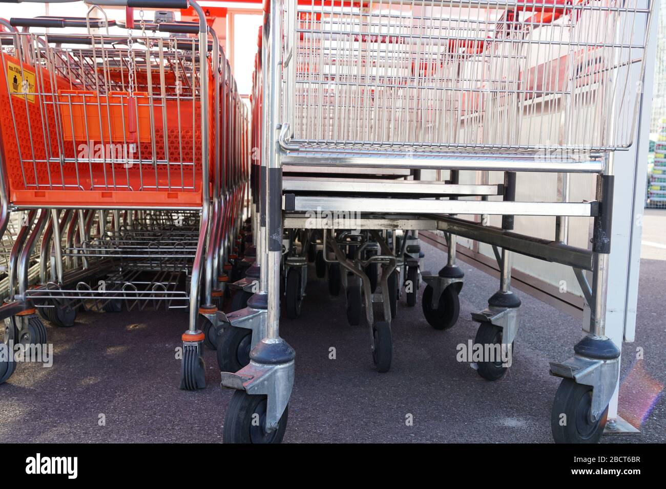 two different type of shopping carts, in a row stocked to one another. No shopping because of lockdown of corona virus, corona crisis or COVID-19. One Stock Photo