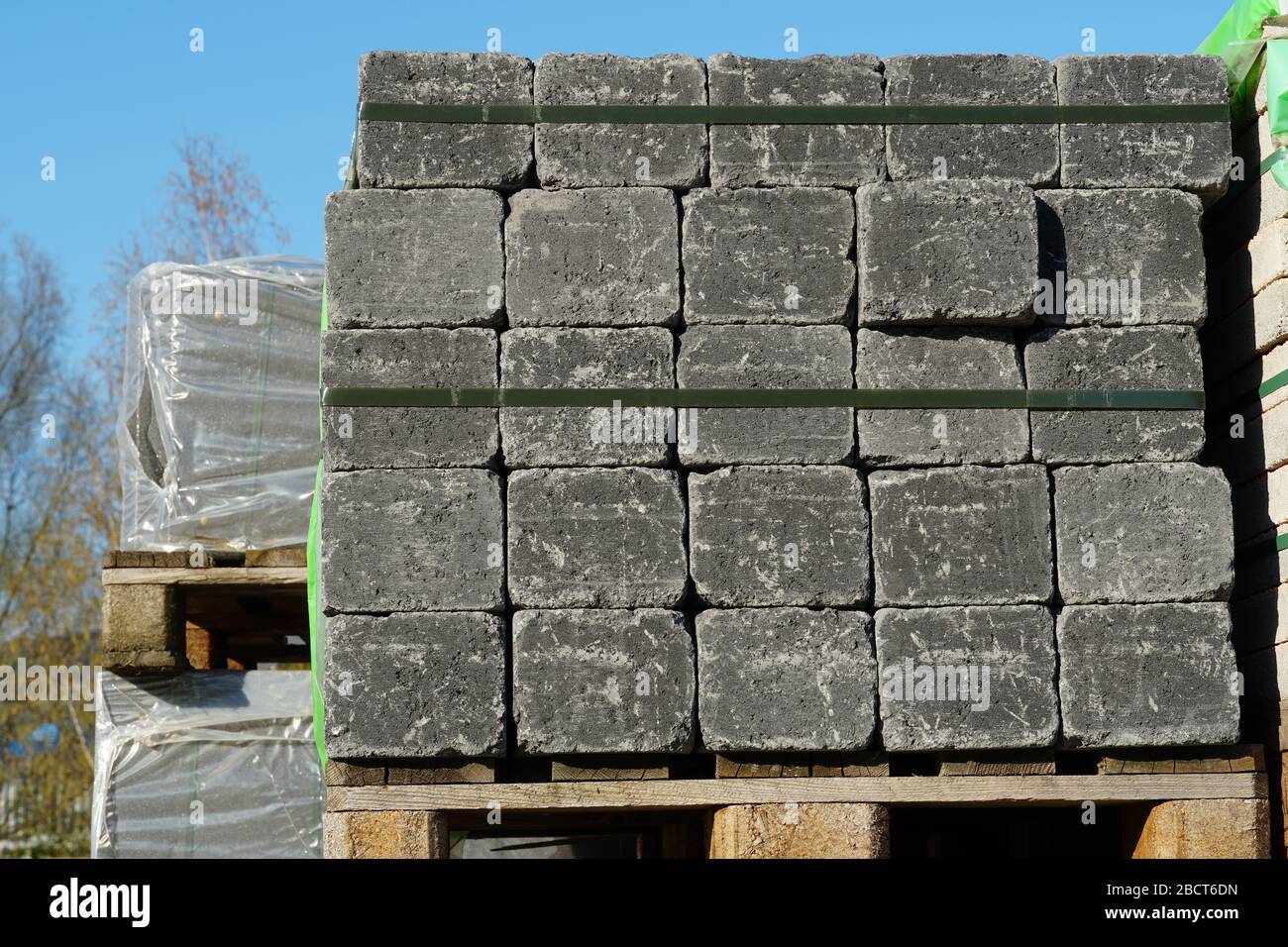 Concrete cubes or cobble stones stapled and attached pallettes in warehouse for building or construction material Stock Photo