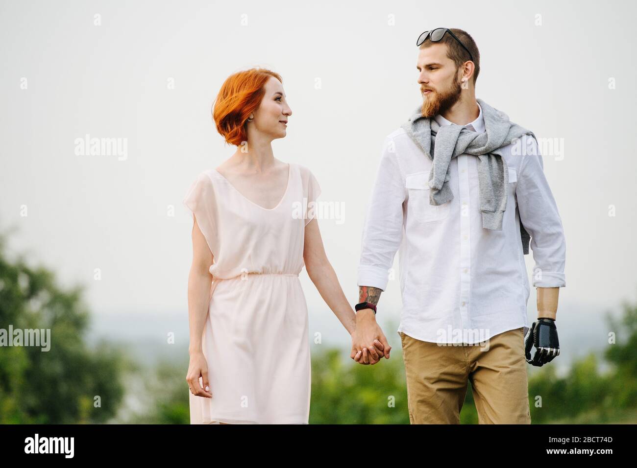 Happy married couple in love walking through a park hand by hand Stock ...
