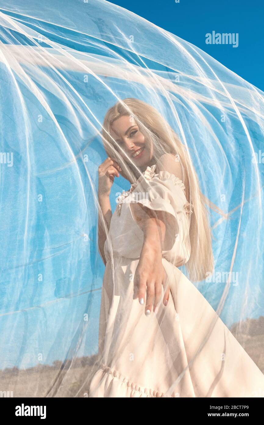 Portrait of a beautiful girl, blonde with long hair in the field, after ...
