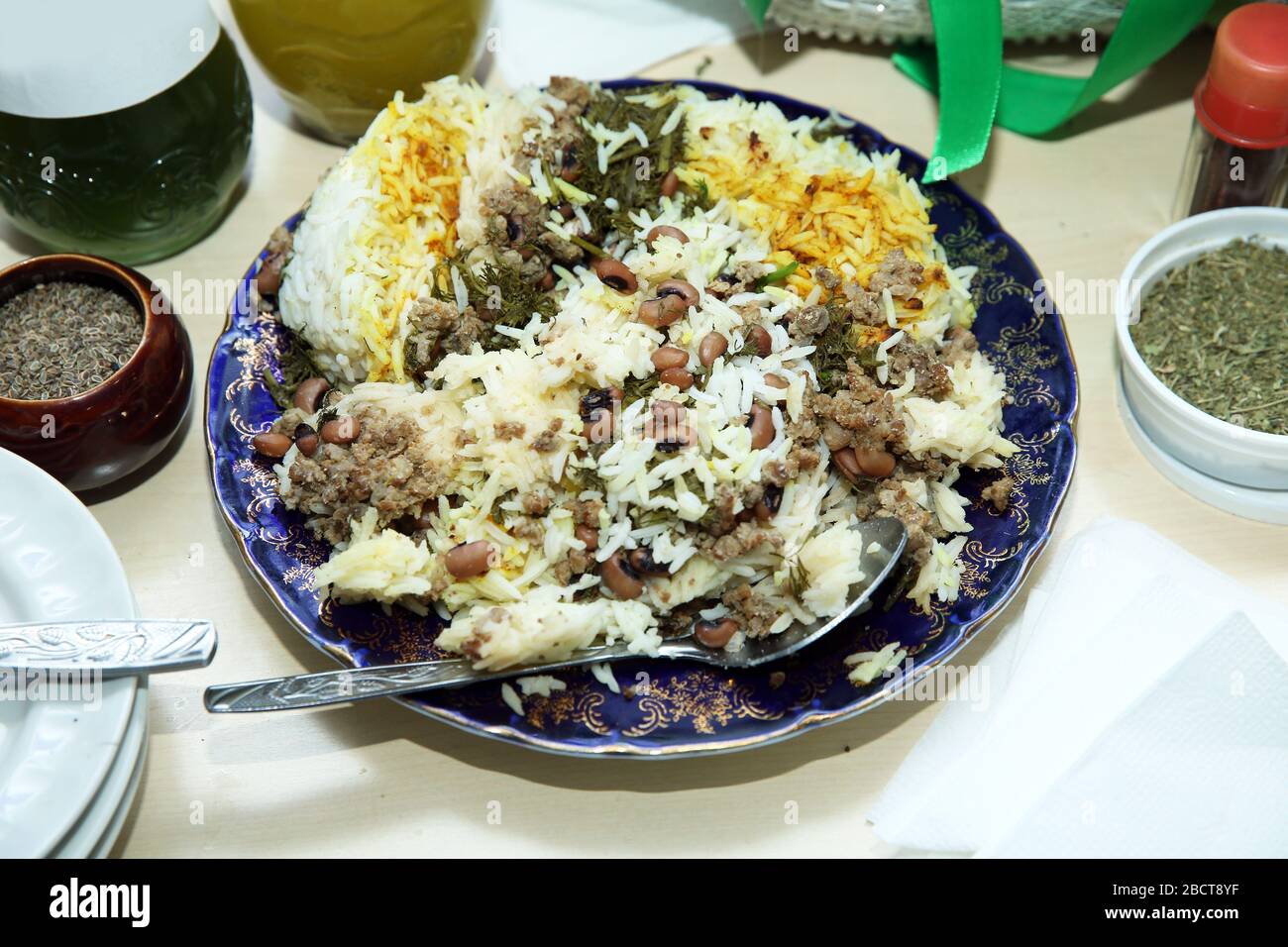 Traditional oriental dish . on tableware . Azerbaijan , Baku . Shah Pilaf with fire on a table