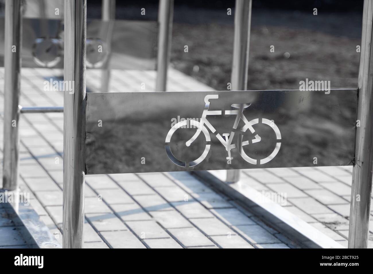 Empty bicycle parking with a sign of bicycle on a street. Stock Photo