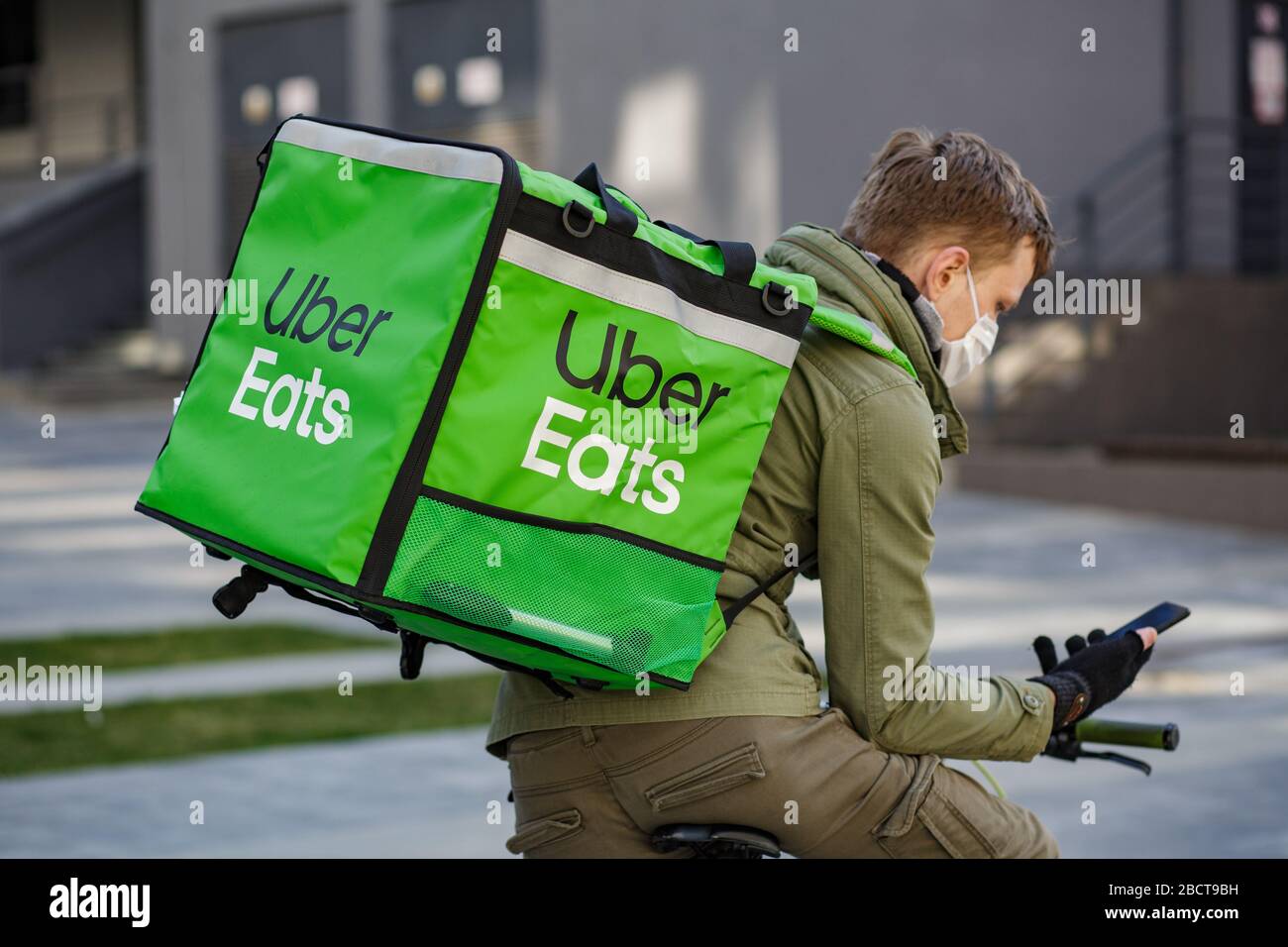 Food supplier with Uber Eats backpack riding a bike on the stree Stock  Photo - Alamy