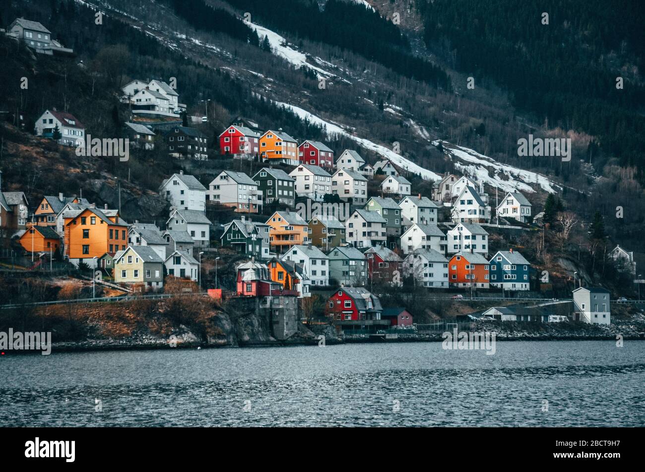 Village in Norway. Typical houses near by lake in the sharp hill ...