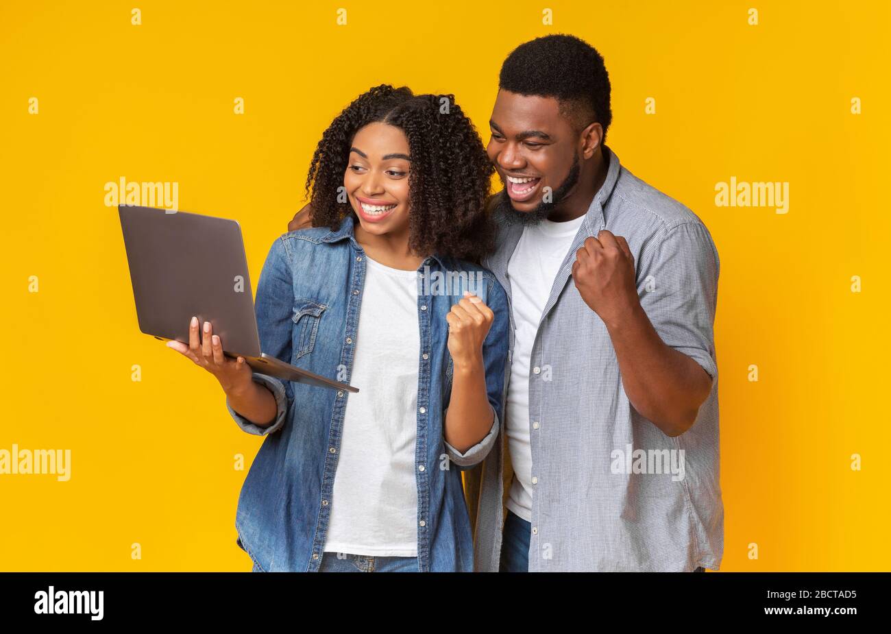 Smiling African American Couple Watching Sports On Laptop Together And ...
