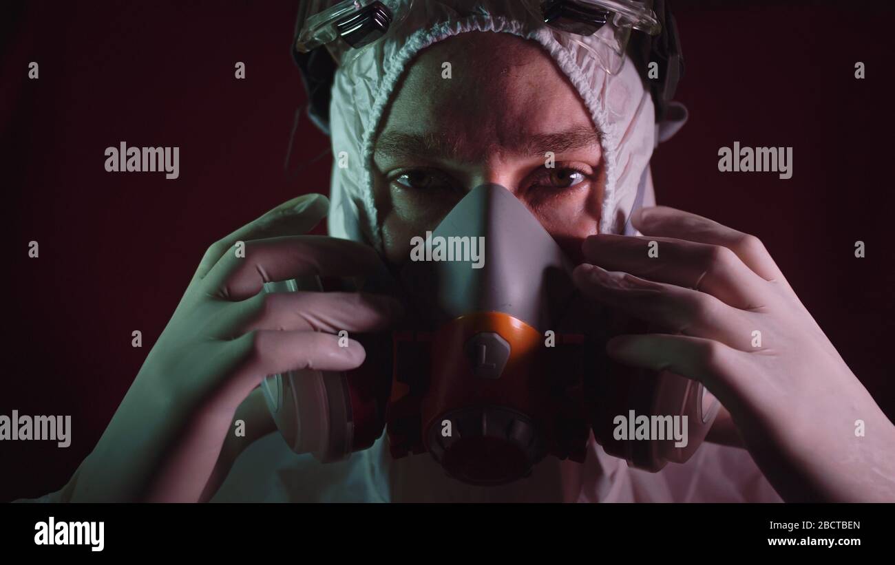 Man in protective costume suit, gas protect medical spray paint mask
