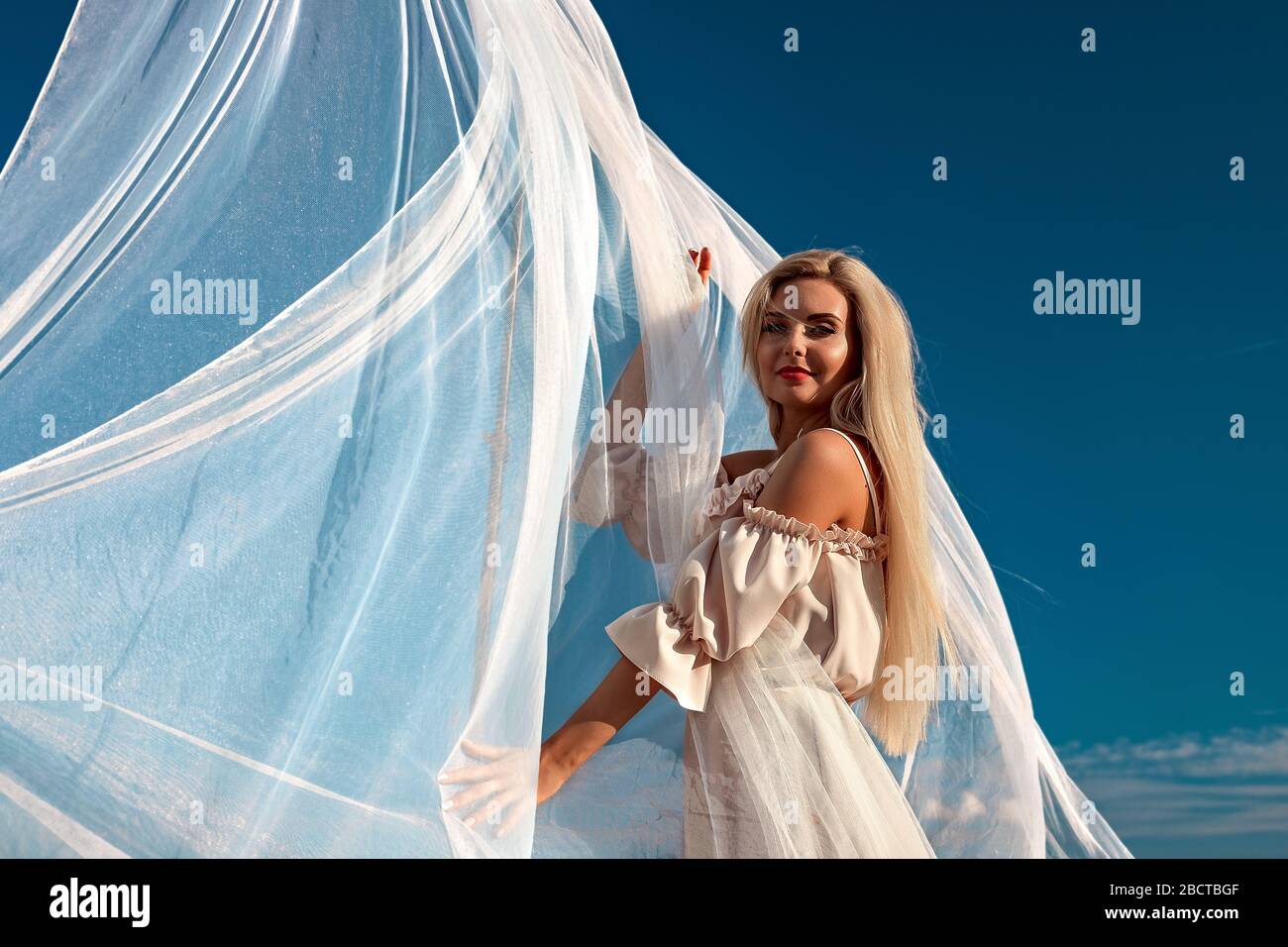 Portrait of a beautiful girl, blonde with long hair in the field, after ...