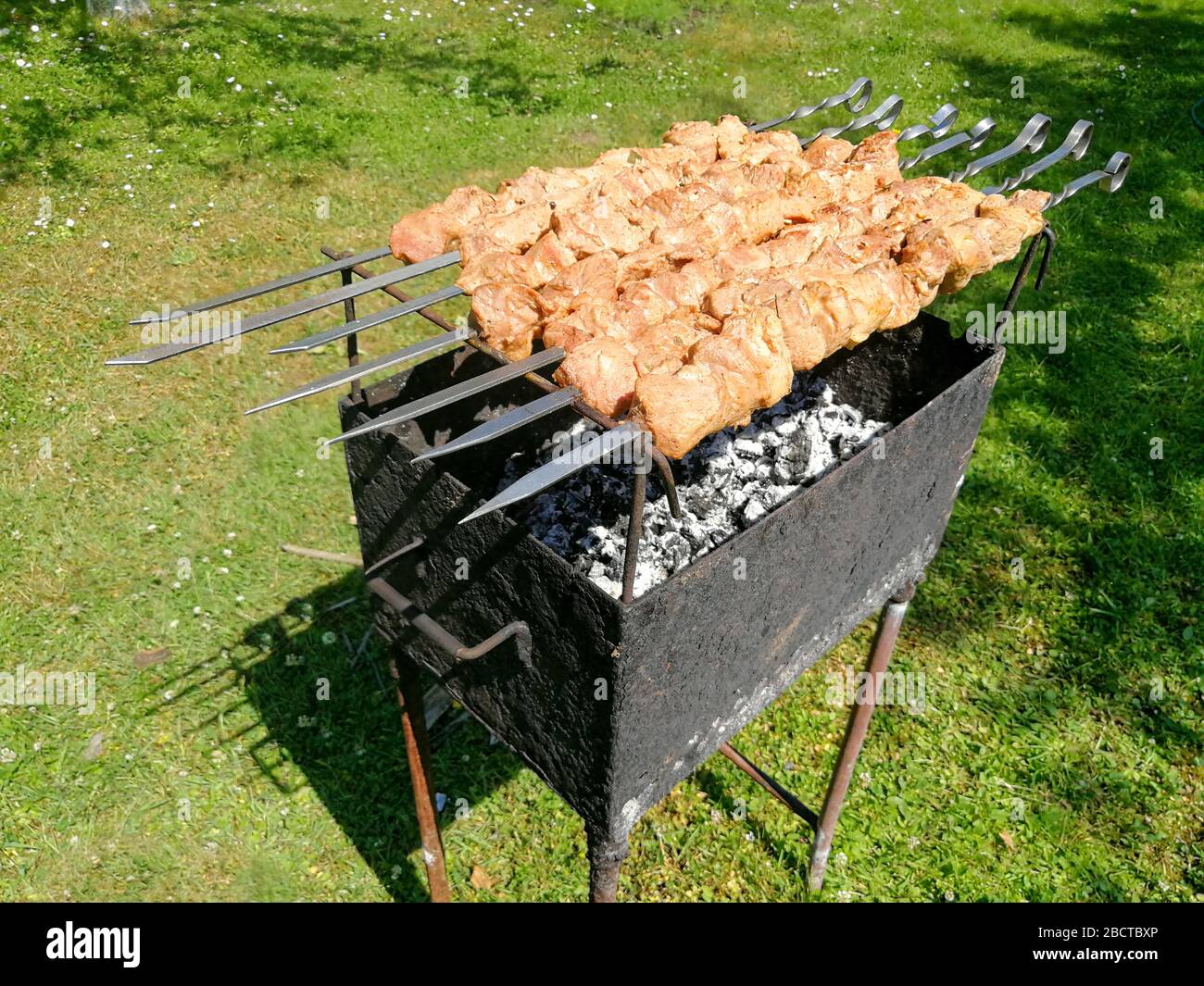 Saslykai or shashlyk grilling on a barbecue grill over charcoal.  Traditional Lithuanian summer dish usual;ly grilled in gardens Stock Photo  - Alamy