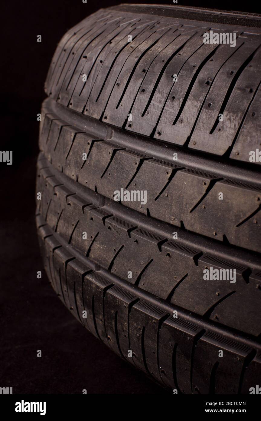 Protector of vehicle tire close up in front of dark background Stock Photo
