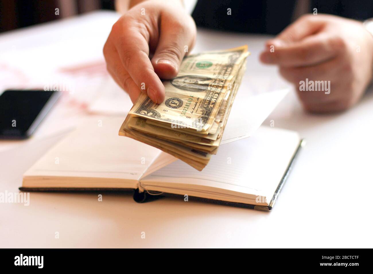 Hands of businessman with paper money. Home office. Counting the salary
