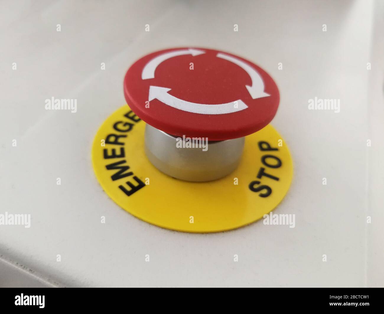 Red button on industrial machine for cancel and emergency stop of