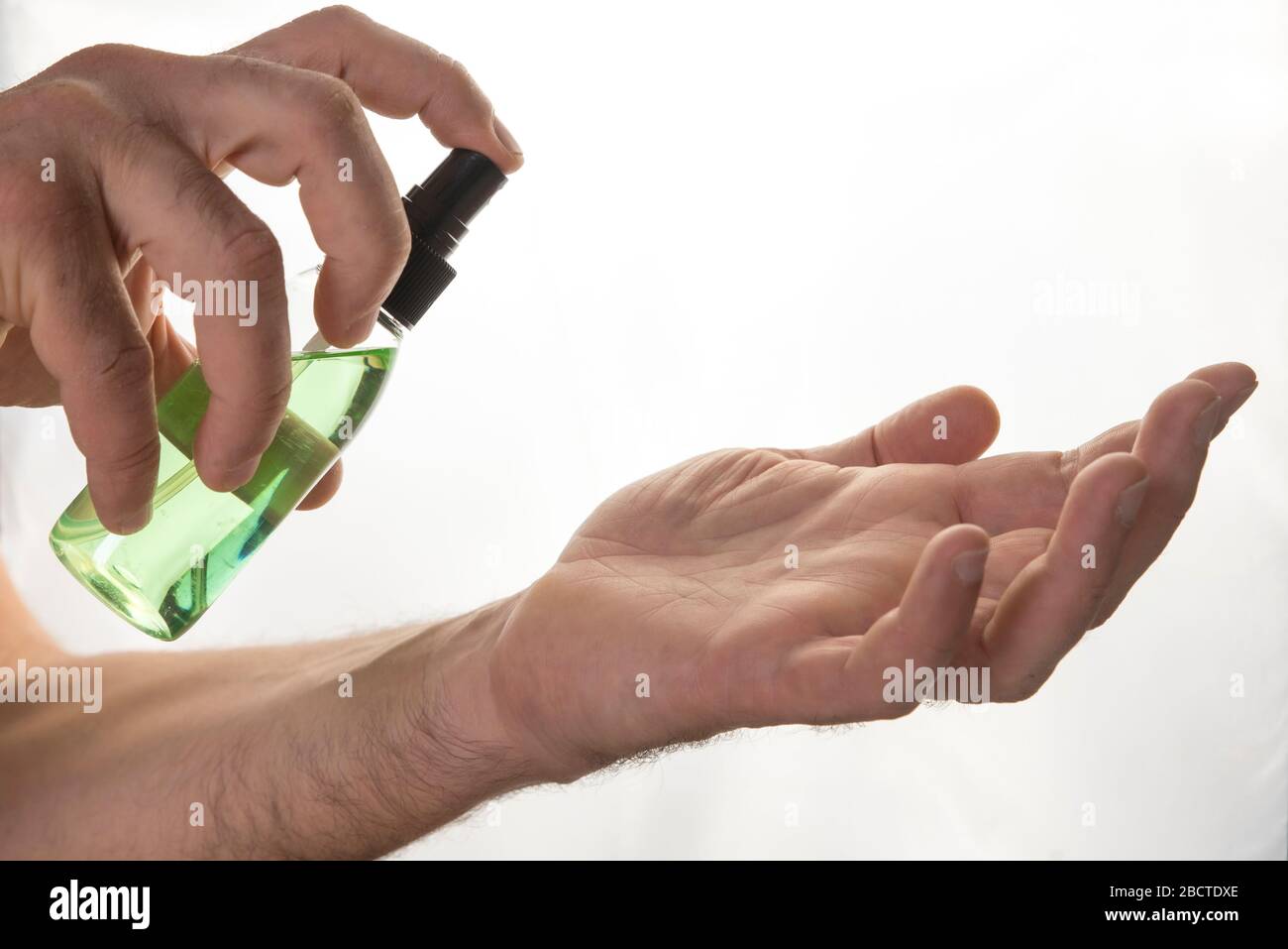 Man uses alcoholic hand sanitizer gel. Prevention from coronavirus to other infectious diseases. Hygiene concept Stock Photo