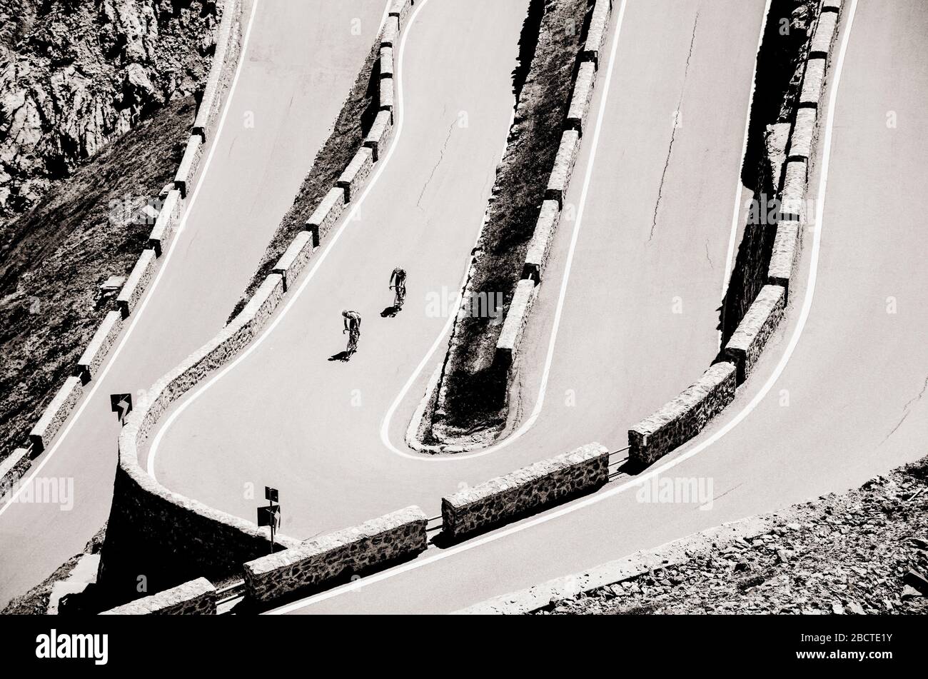 Biker on the road - Cyclist photo. Tour, Italy, Passo dello Stelvio Stock Photo
