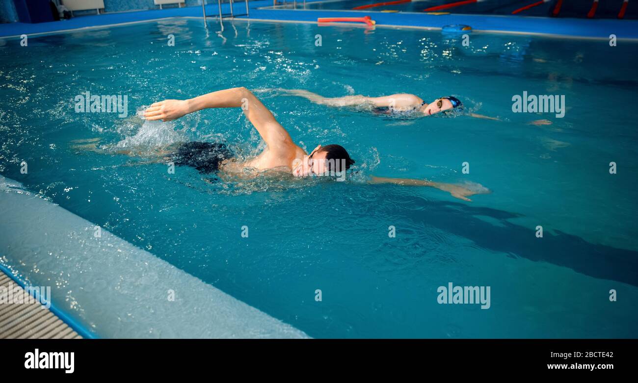 Male and female swimmers swims in the pool Stock Photo Alamy