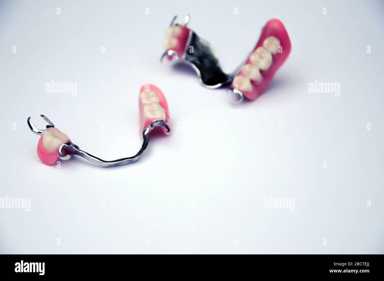 set of fake teeth on a light background. dental prosthetics concept