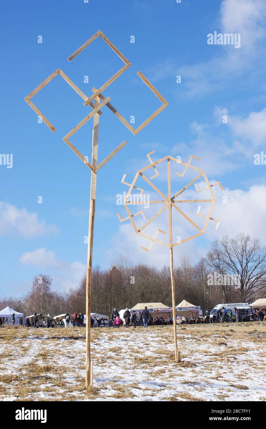 Traditional lithuanian ethno symbols made from wood in front of blue spring sky Stock Photo