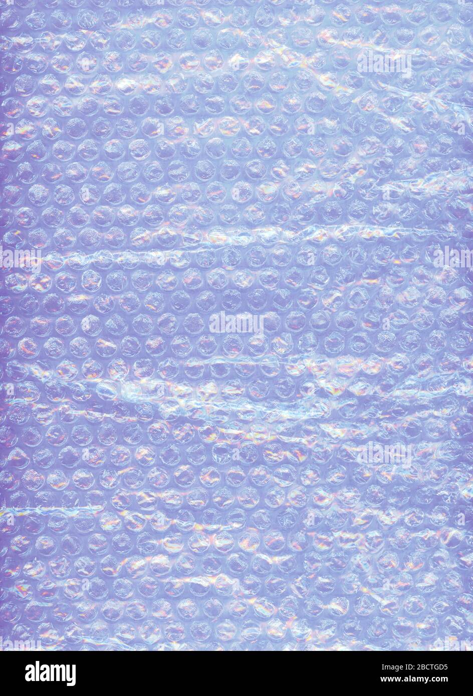 Plastic bubble packing material with a hint of pink and purple, close