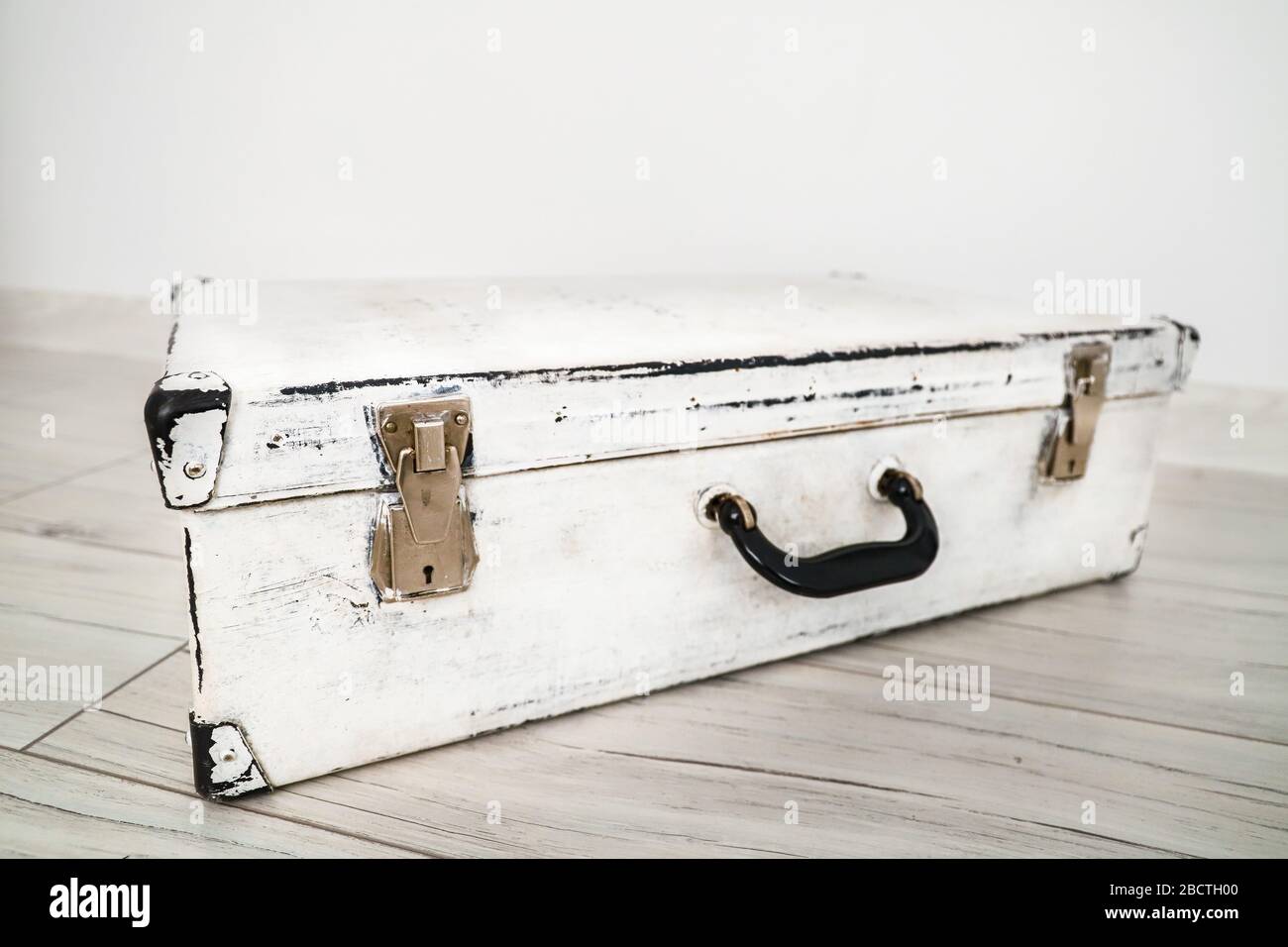 Used old vintage white suitcase on the 