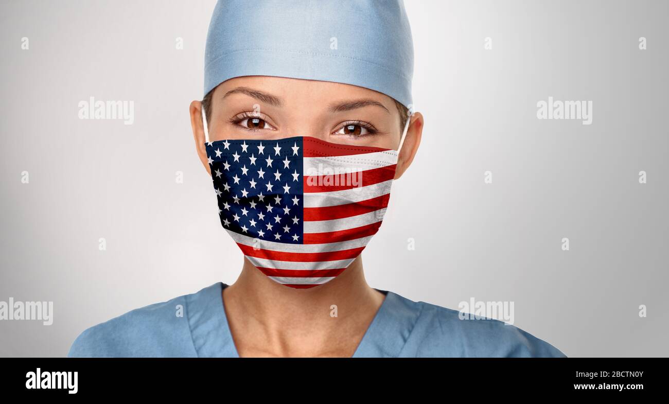 USA American doctor wearing Coronavirus pandemic COVID-19 mask in the United States of America. American flag print on Asian woman doctor's mask smiling in confidence giving hope . Stock Photo