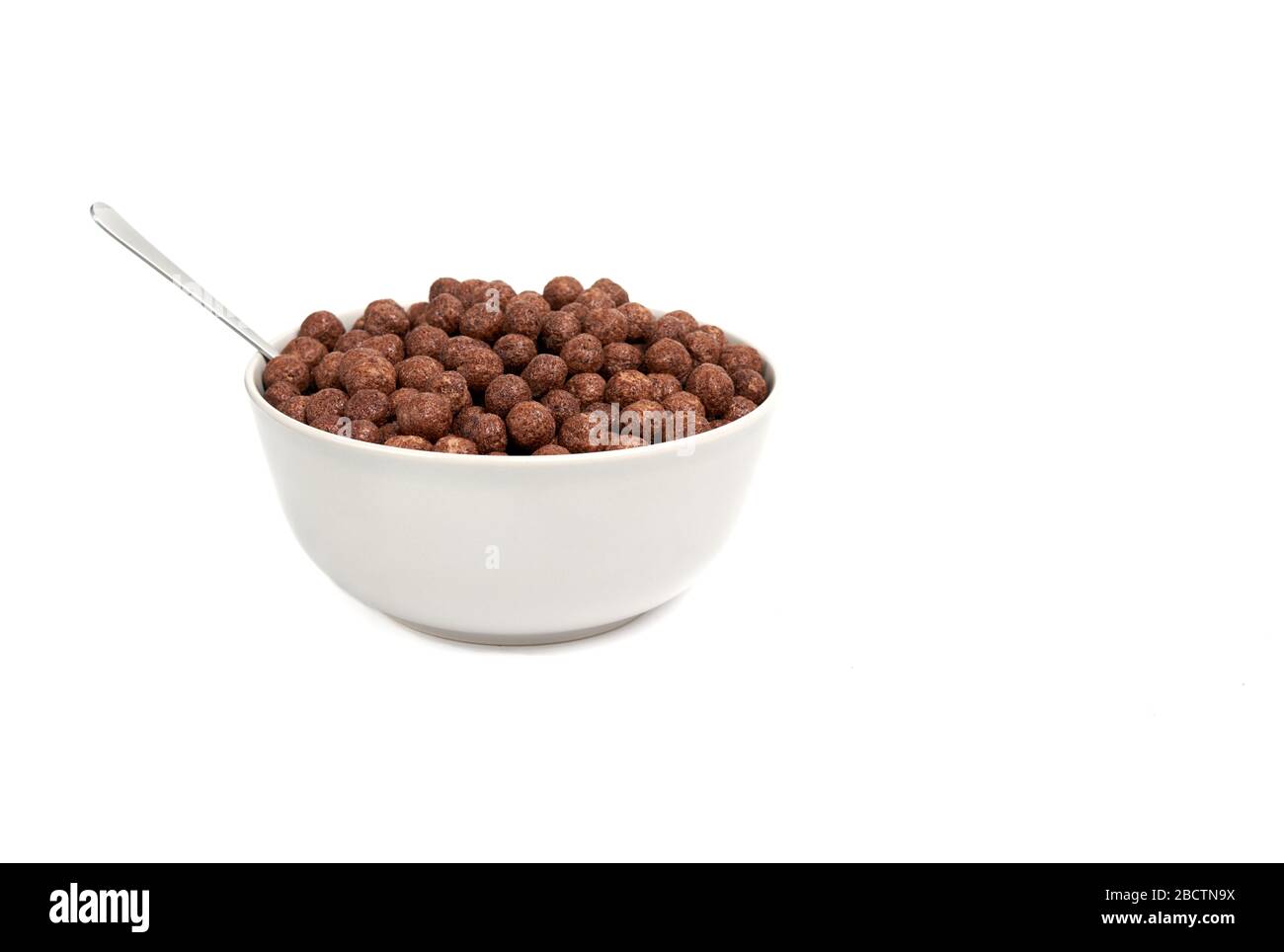 chocolate balls falling into bowl isolated Stock Photo